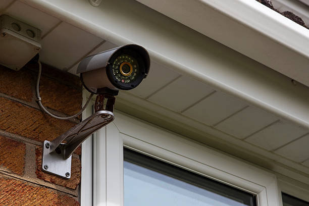Home exterior security camera mounted near an entryway