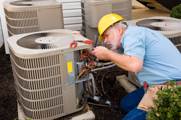 HVAC technician repairing air conditioning unit
