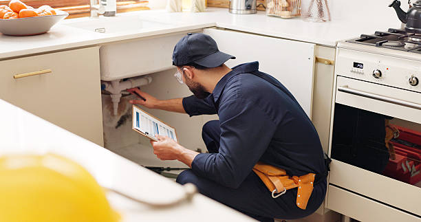 Plumber servicing kitchen sink