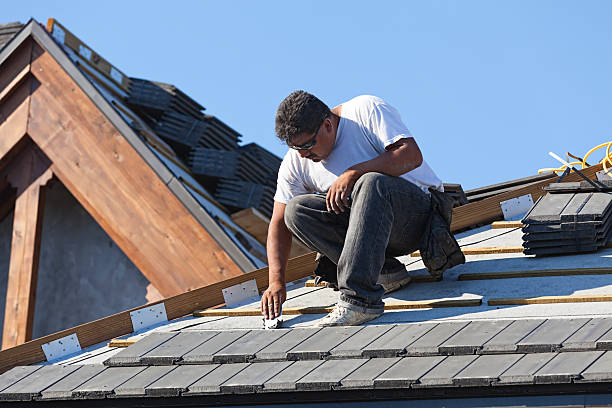Roofer inspecting asphalt shingles
