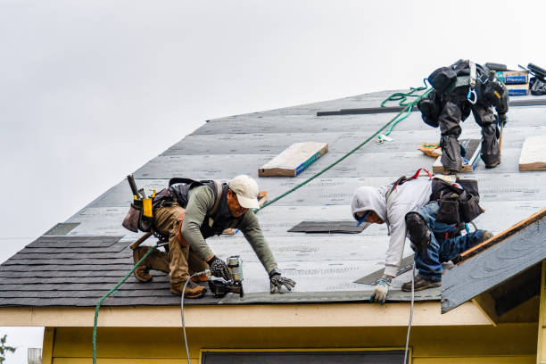 Roofers installing shingles on residential home